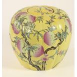 A CHINESE PORCELAIN JAR AND COVER of lobed ovoid form painted with fruiting peach boughs on a yellow