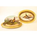 A PAIR OF ENGLISH CHINA OVAL PLAQUES, early 20th century, painted in polychrome enamels by J E