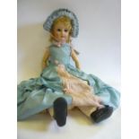 An S.F.B.J. bisque head doll with blue glass sleeping eyes, open mouth and teeth, blonde mohair wig,
