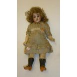 A German bisque head doll with blue glass sleeping eyes, open mouth and teeth, brown mohair wig,