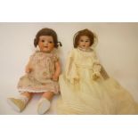 An Armand Marseille bisque head doll with brown glass sleeping eyes, open mouth and teeth, brown