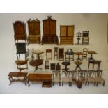 A collection of Brian Masters dolls house furniture comprising ebonised cabinet, rocking chair,