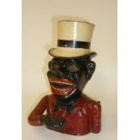 A cast iron Jolly Nigger Bank, English late 19th century, with top hat well, fully operating