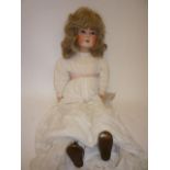 A Cuno & Otto Dressel bisque head girl doll with blue glass sleeping eyes, open mouth and teeth, ash