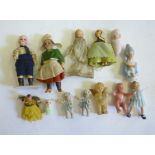 Nine various dolls house dolls, three with bisque heads, two in painted metal, one rubber, three