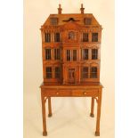 A cocktail cabinet/doll's house by Maitland-Smith in the form of a Georgian house in stained