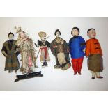 A pair of Chinese composition dolls as an old couple, in full costume with hats, 9 1/2" high, and