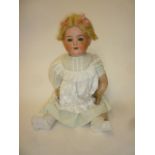 An Ernst Heubach bisque head doll with blue glass fixed eyes, open mouth and teeth, blonde mohair