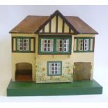 A Triang doll's house, painted half timbered wood construction with hipped roof, opening front,