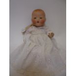 An Armand Marseille bisque head Dream Baby doll, with fixed blue glass eyes, open mouth and teeth,