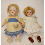 An Armand Marseille bisque head character girl doll with blue glass sleeping eyes, open mouth and