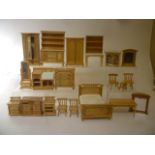 A quantity of mainly Chinese made light wood dolls house furniture including a bedroom suite, a