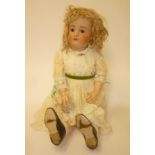 A Heinrich Handwerck bisque head doll with brown glass sleeping eyes, open mouth and teeth,