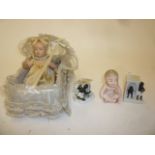 A French celluloid doll with swivel limbs, painted face, 7" high, in lace trimmed crib, an all