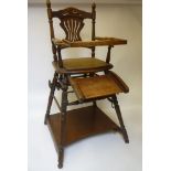 An early 20th century child's metamorphic high chair, in stained beech, with tray, footrest and
