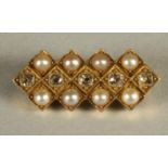 A VICTORIAN DIAMOND AND PEARL BROOCH, the central panel millegrain set with five old brilliant cut