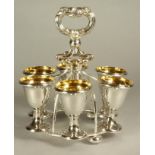 AN OLD SHEFFIELD PLATE EGG CRUET, the six pedestal egg cups supported on a wirework circular frame