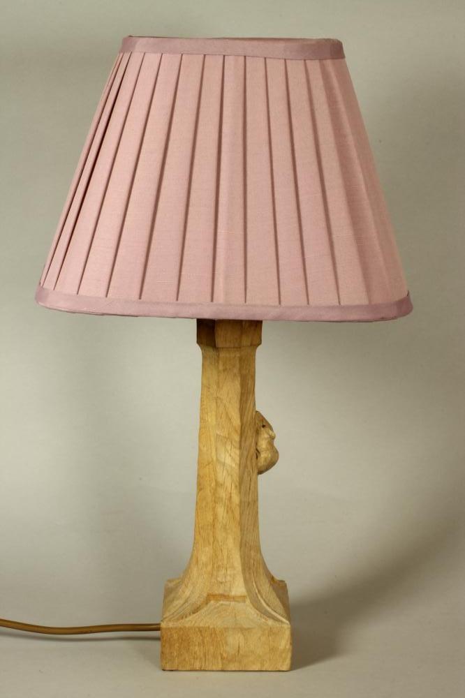 A ROBERT THOMPSON ADZED OAK TABLE LAMP, the faceted tapering stem with carved mouse trademark in