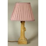 A ROBERT THOMPSON ADZED OAK TABLE LAMP, the faceted tapering stem with carved mouse trademark in