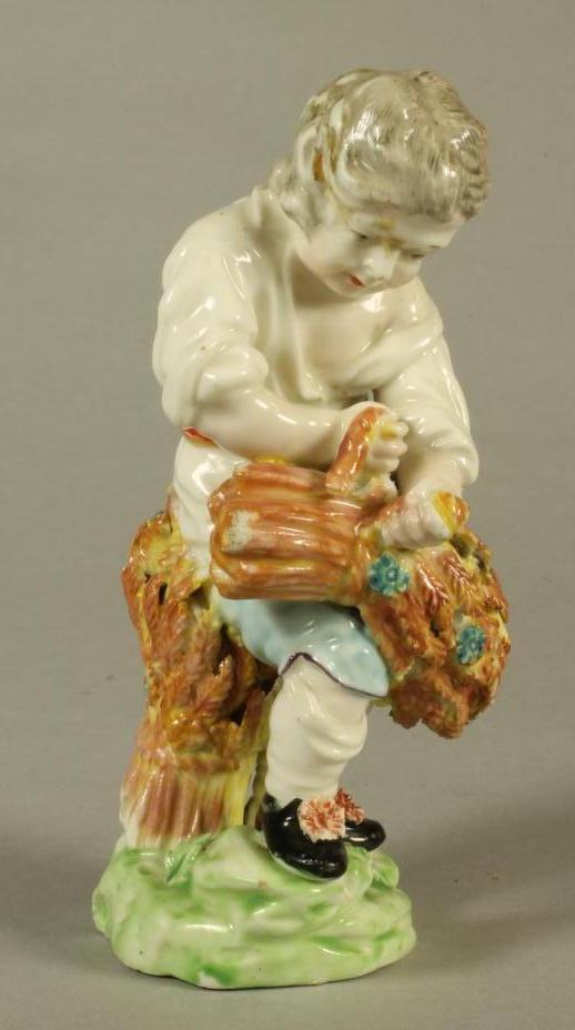 A DERBY PORCELAIN FIGURE, c.1770, allegorical of Autumn modelled as a young boy wearing a white open