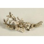 A LATE VICTORIAN DIAMOND FLOWER SPRAY BROOCH with central flowerhead issuing from a ribbon tied