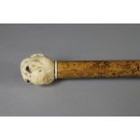 A VICTORIAN WALKING STICK, the malacca shaft with copper tip, carved ivory grip as a monkey head