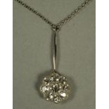 A DIAMOND CLUSTER PENDANT, the central brilliant cut stone of approximately 0.20cts, millegrain