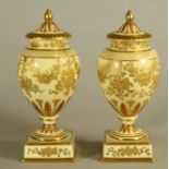 A PAIR OF WEDGWOOD CHINA VASES AND COVERS, early 20th century, with stiff leaf moulded everted