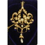 A LATE VICTORIAN 15CT GOLD PENDANT/BROOCH of open cartouche form set with numerous seed pearls and