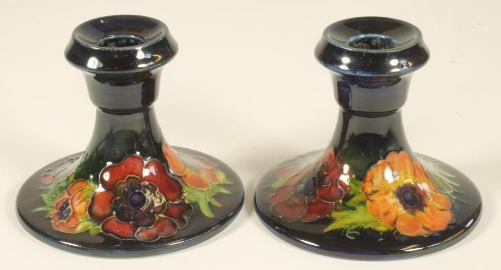 A PAIR OF MOORCROFT POTTERY DWARF CANDLESTICKS, mid 20th century, the bell shaped sockets issuing