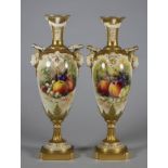 A MATCHED PAIR OF ROYAL WORCESTER CHINA VASES, 1912 and 1913, of slender ovoid form with arcade