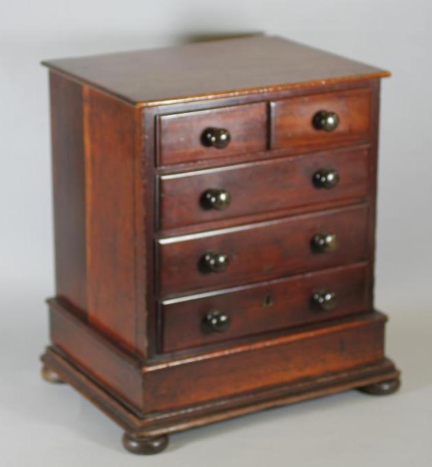 A VICTORIAN MAHOGANY MINIATURE CHEST of two short and three long drawers with turned wood handles,