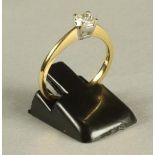 A SOLITAIRE DIAMOND RING, the princess cut stone of 0.25cts claw set to a plain 18ct gold shank,