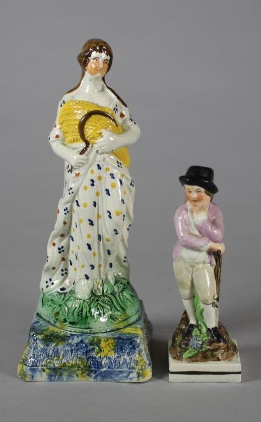 A PEARLWARE FIGURE, early 19th century, modelled as Ceres standing holding a sheaf of corn and a