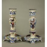 A COMPOSITE PAIR OF FRENCH FAIENCE CANDLESTICKS, late 19th century and later, fixed quatrefoil