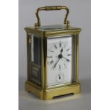A BRASS CASED CARRIAGE CLOCK, the twin train movement with cylinder escapement striking on a bell,