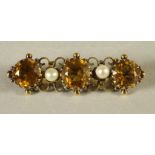 A VICTORIAN CITRINE AND PEARL BAR BROOCH, the three facet cut circular citrines interspersed with