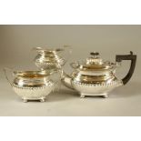 A MATCHED THREE PIECE SILVER TEA SERVICE, teapot makers Martin, Hall & Co., Birmingham 1919, a two