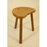 A ROBERT THOMPSON ADZED OAK STOOL, the kidney shaped seat with carved mouse trademark in high relief