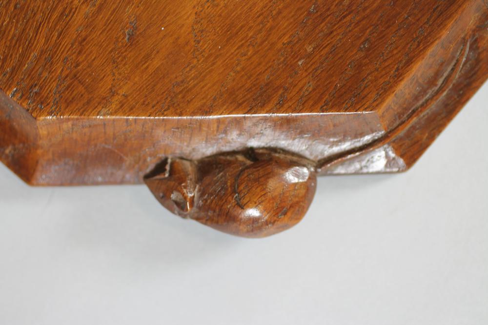 A ROBERT THOMPSON ADZED OAK BREADBOARD, of canted oblong form, the moulded edge with carved mouse - Image 2 of 2