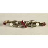 A VICTORIAN RUBY, DIAMOND AND PEARL BAR BROOCH, the knife edge bar centrally claw set with three