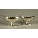 A COMPOSITE PAIR OF GEORGE III SILVER SALTS, maker Robert Hennell, London 1785, and makers R & S