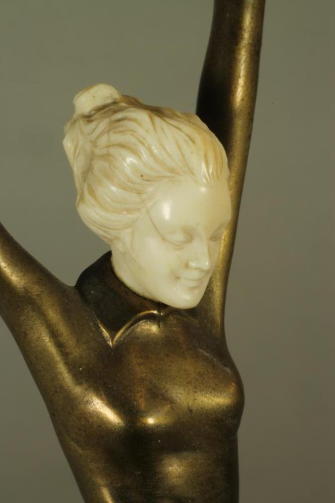 AN ART DECO BRONZE FIGURE OF A YOUNG FEMALE with carved ivory head, standing on her left leg with - Image 3 of 4