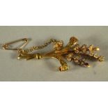 AN 18CT GOLD SPRAY BROOCH, the Lily of the Valley with diamond points, 7.4g gross