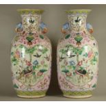 A PAIR OF CHINESE PORCELAIN VASES of rounded cylindrical form with elephant mask handles, painted in