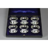 A SET OF SIX EDWARDIAN SILVER NAPKIN RINGS, maker Robert Pringle, London 1908, of waisted