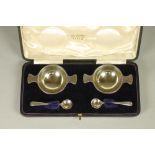 A PAIR OF EDWARDIAN SILVER SALTS, makers Nathan & Hayes, Chester 1907, in the form of a quaiche,