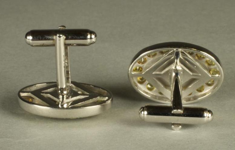 A PAIR OF YELLOW SAPPHIRE SET CUFFLINKS, the oval panels centred by a collet set stone on a yellow - Image 2 of 2