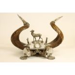 A VICTORIAN RAM'S HORN DESK STAND, the pair of horns with silver plated fern engraved foliate tips