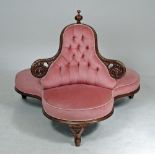 A VICTORIAN WALNUT FRAMED CHAPERONE SOFA button upholstered in pink dralon and surmounted by a